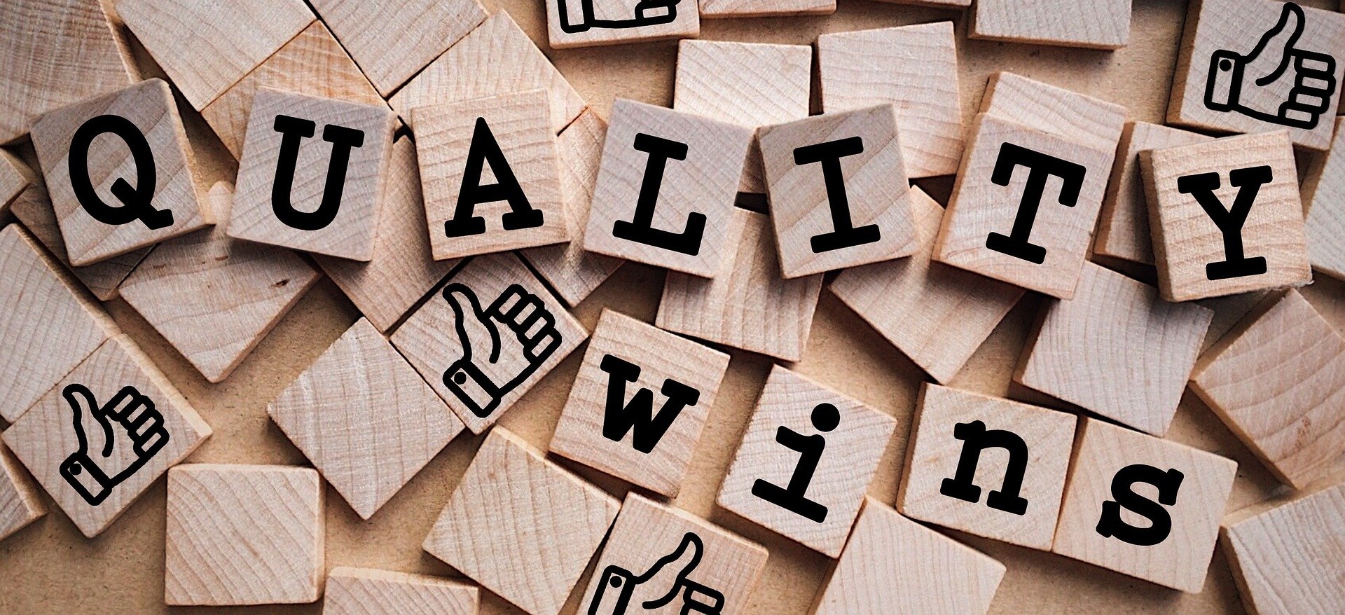 Wooden letter tiles spelling quality wins